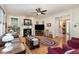 Spacious living room with fireplace, wood floors, ceiling fan and a neutral color palette at 457 Poplar Forest Ln, Pittsboro, NC 27312