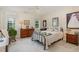 Cozy primary bedroom featuring a comfortable bed, dresser, and ample natural light from windows at 457 Poplar Forest Ln, Pittsboro, NC 27312
