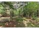 Picturesque wooded area with a stone bench and a wooden picnic table at 457 Poplar Forest Ln, Pittsboro, NC 27312