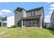The back of the house shows a large, screened-in porch that opens to a grassy backyard at 4940 Enlightenment Rd, Raleigh, NC 27616