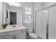 Bright bathroom has a vanity with storage and a tiled shower at 4940 Enlightenment Rd, Raleigh, NC 27616