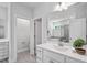 Bright bathroom featuring double sink vanity, and a glass enclosed shower at 4940 Enlightenment Rd, Raleigh, NC 27616