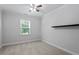 This bedroom has a ceiling fan and large window at 4940 Enlightenment Rd, Raleigh, NC 27616