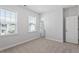 Bright bedroom with neutral walls, plush carpeting, and dual windows creates an airy, inviting space at 4940 Enlightenment Rd, Raleigh, NC 27616