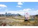 Community farm featuring garden plots and greenhouse with colorful signage at 4940 Enlightenment Rd, Raleigh, NC 27616