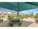 Community garden featuring a shaded seating area, picnic tables, and raised garden beds for residents' enjoyment at 4940 Enlightenment Rd, Raleigh, NC 27616