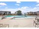 Zero entry community pool with splash pad and lounge seating surrounded by neighborhood townhomes at 4940 Enlightenment Rd, Raleigh, NC 27616