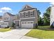 Beautifully landscaped two-story home with an attached garage and well-maintained green lawn at 4940 Enlightenment Rd, Raleigh, NC 27616