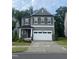 Charming two-story home features a large garage, landscaped yard, and inviting entrance at 4940 Enlightenment Rd, Raleigh, NC 27616