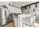 Modern kitchen with stainless steel appliances, wooden floors, and an open breakfast bar at 4940 Enlightenment Rd, Raleigh, NC 27616