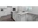 The kitchen island includes a sink, dishwasher, and barstool seating at 4940 Enlightenment Rd, Raleigh, NC 27616
