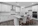 This updated kitchen has stainless steel appliances, a kitchen island, and stylish finishes at 4940 Enlightenment Rd, Raleigh, NC 27616