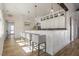 Clubhouse kitchenette with white cabinets, bar seating and modern fixtures at 4940 Enlightenment Rd, Raleigh, NC 27616