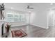 Open living room with ceiling fan, access to back patio and a fireplace at 4940 Enlightenment Rd, Raleigh, NC 27616