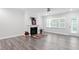 Spacious living room features lots of windows, a ceiling fan, and fireplace at 4940 Enlightenment Rd, Raleigh, NC 27616
