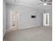 Spacious main bedroom with neutral carpet, ceiling fan and tray ceiling, and en-suite bathroom access at 4940 Enlightenment Rd, Raleigh, NC 27616