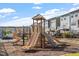 Community playground with slides and climbing structures alongside neighborhood townhomes at 4940 Enlightenment Rd, Raleigh, NC 27616