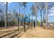Outdoor playground with various exercise equipment, surrounded by trees and greenery at 4940 Enlightenment Rd, Raleigh, NC 27616