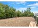 Community playground with climbing equipment and seating area surrounded by trees at 4940 Enlightenment Rd, Raleigh, NC 27616