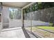 Bright screened-in porch with a view of the landscaped backyard and white fence at 4940 Enlightenment Rd, Raleigh, NC 27616