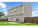 View of back exterior with small patio, lawn and partial fenced yard at 504 Gumview Cir, Fuquay Varina, NC 27526