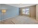 Bedroom featuring carpet, blue accent wall and a window at 504 Gumview Cir, Fuquay Varina, NC 27526
