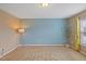 Bedroom featuring carpet, blue accent wall and a window with curtains at 504 Gumview Cir, Fuquay Varina, NC 27526