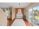 Warm dining area with dark wood floors, view of the backyard, and modern lighting fixture at 504 Gumview Cir, Fuquay Varina, NC 27526