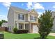Charming two-story home with a manicured lawn, stone accents, and an attached one car garage at 504 Gumview Cir, Fuquay Varina, NC 27526