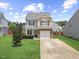 Charming two-story home with a manicured lawn, stone accents, and an attached one car garage at 504 Gumview Cir, Fuquay Varina, NC 27526