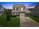 Charming two-story home with a manicured lawn, stone accents, and an attached one car garage at 504 Gumview Cir, Fuquay Varina, NC 27526