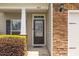 Elegant front entrance with a stone facade, decorative shrubbery, and glass paneled door at 504 Gumview Cir, Fuquay Varina, NC 27526