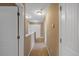 A well-lit hallway features neutral paint, carpet flooring, and white doors at 504 Gumview Cir, Fuquay Varina, NC 27526