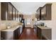 Stylish kitchen features stainless steel appliances, granite countertops, and dark wood cabinets at 504 Gumview Cir, Fuquay Varina, NC 27526