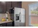 Kitchen features stainless steel refrigerator, granite countertops, and a window with natural light at 504 Gumview Cir, Fuquay Varina, NC 27526