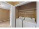 Laundry room with a washer and dryer with shelving at 504 Gumview Cir, Fuquay Varina, NC 27526