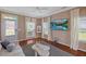 Bright living room featuring a comfortable sofa, a large window, and a flat-screen television at 504 Gumview Cir, Fuquay Varina, NC 27526