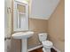Powder room with a pedestal sink, toilet, and mirror at 504 Gumview Cir, Fuquay Varina, NC 27526