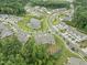 Aerial view of neighborhood featuring a pond surrounded by single Gathering homes and townhomes at 515 Historic Dr, Hillsborough, NC 27278