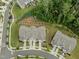 Aerial view of townhomes featuring well-maintained landscaping and a nearby parking area at 515 Historic Dr, Hillsborough, NC 27278