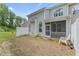 View of the backyard with a screened porch, white fence, and minimal grass at 515 Historic Dr, Hillsborough, NC 27278