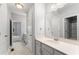 Well-lit bathroom with a single vanity, modern sink, and a door leading to additional spaces at 515 Historic Dr, Hillsborough, NC 27278