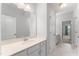 Bright bathroom featuring a vanity with a sink, a large mirror, and views into adjacent rooms at 515 Historic Dr, Hillsborough, NC 27278