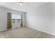 Bright bedroom with a neutral carpet, a window dressed with neutral-tone curtains for a serene ambiance at 515 Historic Dr, Hillsborough, NC 27278