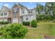A charming two-story townhome with a brick facade, attached garage, and well-maintained landscaping at 515 Historic Dr, Hillsborough, NC 27278