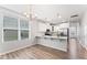 Open-concept kitchen with white cabinets, countertops, and modern appliances at 515 Historic Dr, Hillsborough, NC 27278