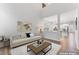 A bright living room with high ceilings, a comfortable sofa, and an open view of the kitchen at 515 Historic Dr, Hillsborough, NC 27278