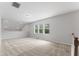Spacious loft area featuring neutral carpet, three windows offering natural light and scenic views at 515 Historic Dr, Hillsborough, NC 27278