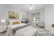 A serene staged bedroom with soft lighting, a comfortable bed, and neutral decor at 515 Historic Dr, Hillsborough, NC 27278