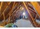 Unfinished attic area with visible framing and a window would make a great storage space at 541 Mallie Pearce Rd, Zebulon, NC 27597